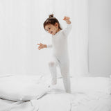 close up of a little girl wearing Rejuvaskin's tencel cotton baby sleepsuit for eczema relief